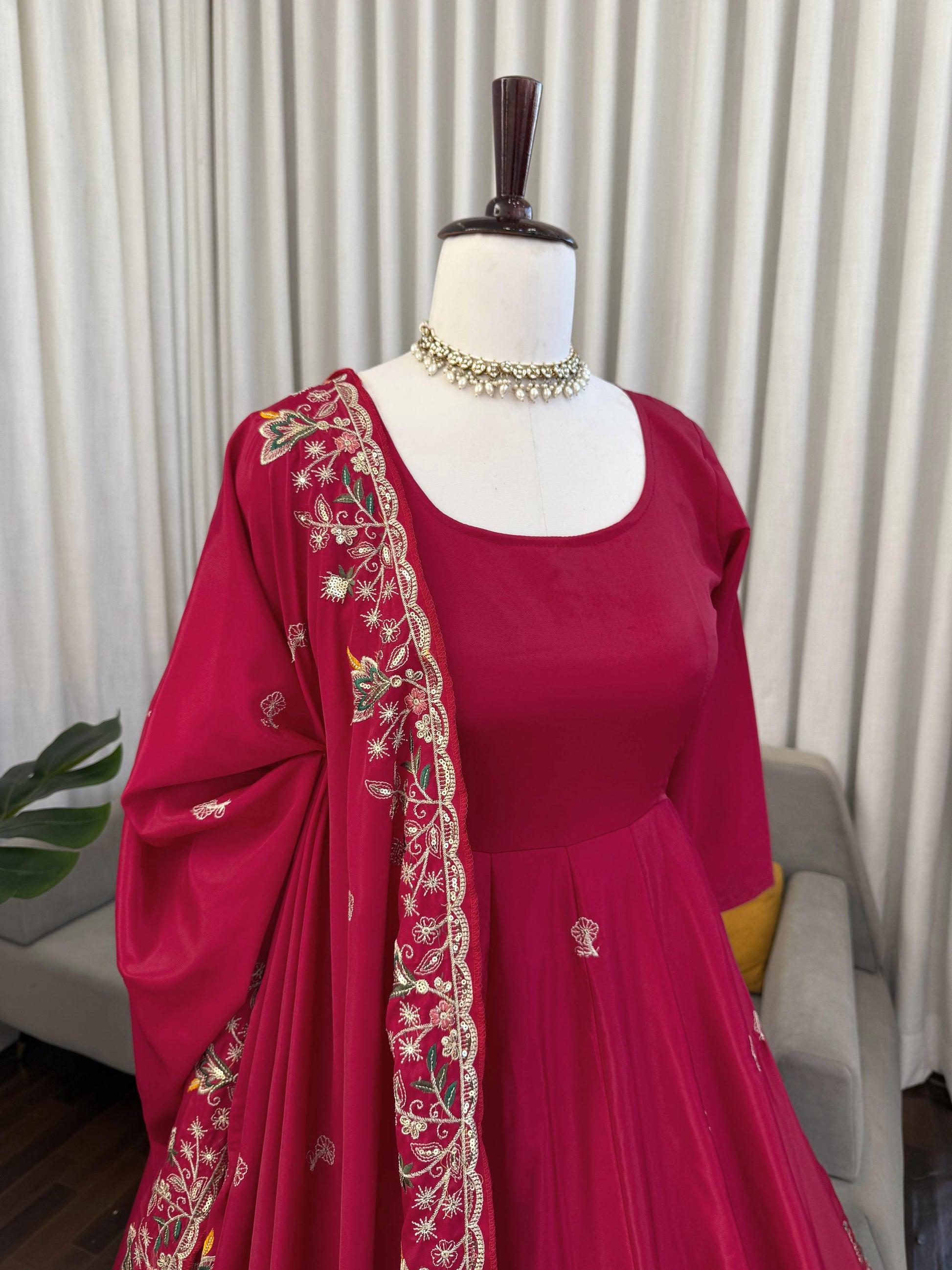 Red embroidered Anarkali suit with floral dupatta, perfect for weddings and festivals